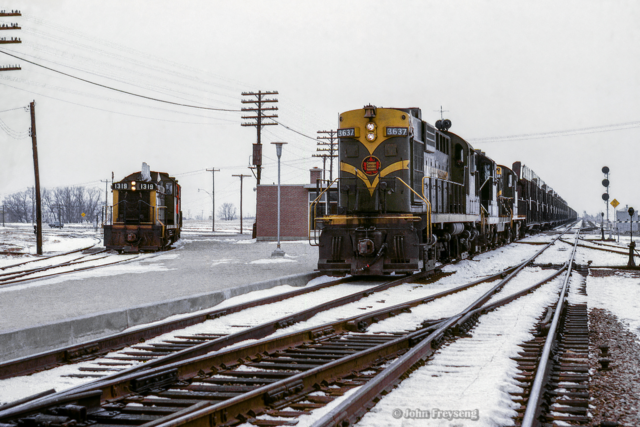 A pair of pups wait on the Uxbridge Sub with a short local while Extra 3637 west flies by on the Oshawa Sub mainline for Mimico.  The new Scarborough Junction station can be seen beyond the power, built in 1964 to replace the second station, which burnt down in 1960.  This structure stood until the Midland Avenue grade separation project in 1977-78.Scan and editing by Jacob Patterson.