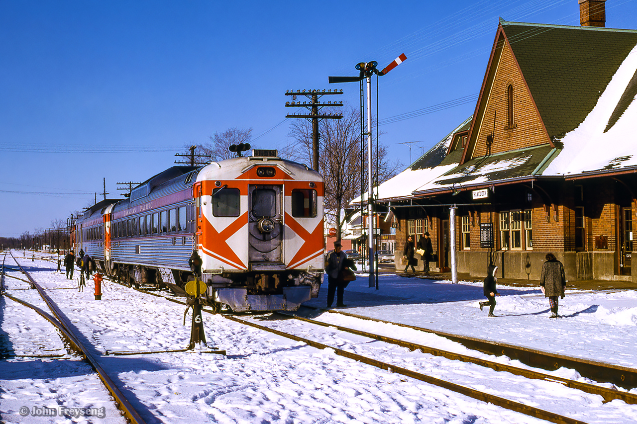 Toronto - Ottawa daily train 34 pauses at Havelock at 1050h.  It will meet its westbound counterpart, 33, 47 miles east of here at Kaladar at 1143h.  This scene was captured during a trip to Smith Falls to ride train 21, a former CNR/CPR pool train, before cancellation as the pool agreement had been cancelled a few months previous.

With both the Canadian National and Canadian Pacific Railways seeing sharp declines in ridership during the Great Depression, both companies entered into an agreement to pool some competitive passenger services on Toronto - Montreal and Toronto - Ottawa routes where both operators had similar schedules. The agreement would come into effect April 2, 1933. Montreal - Quebec City operations were added the following year. This agreement would come to an end at midnight on October 30, 1965. CPR overnight pool trains 33 & 34 became CPR daytime RDC runs Toronto - Peterborough - Havelock - Smiths Falls - Bedell Jct. - Ottawa. The CPR overnight pool trains 21 & 22 became luxury late afternoon trains Toronto - Belleville - Smiths Falls - Montreal using equipment from CPR's Canadian, including dining car and dome-observation lounge Park cars in a vain attempt to compete with CN’s afternoon Rapido’s to/from Montreal. By January 1966, it had become obvious that CP couldn’t effectively compete with the Rapido’s, so CP applied and was granted permission to terminate trains 21 & 22. Wanting to ride #21 before it was discontinued, on this Saturday I made a trip on RDC equipped Ottawa train 33 to Smiths Falls and returned to Toronto on train 21, now named the Royal York. The eastbound counterpart, train #22, carried the name Le Chateau Champlain. Both trains being named after CP hotels at each of their destinations.



Scan and editing by Jacob Patterson.