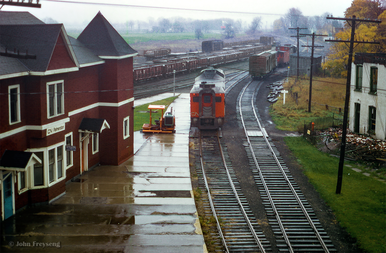 Last CN Passenger service at Palmerston. Operating as extra 6101, former train number 672 - the southbound RDC-1 passenger car from Owen Sound - is seen positioned on the Newton Sub side of the station on Saturday, October 24, 1970 for the final time. Arriving at 0655h, the Railiner will await the arrival of Extra 6354, formerly train 668 (RDC-2) from Southampton. Both will be combined and having met extra 6118 (RDC-1), the former train 662 from Kincardine, will depart at 0715h for the trip to Toronto (formerly train 658) via the Fergus, Guelph, Halton, and Weston Subs. Extra 6118, which had arrived at 0700h from Kincardine, will too depart at 0715h for Stratford.

I believe the official last runs of the RDC service to Owen Sound, Kincardine, Southampton, and Goderich was the evening of Fri Oct 23, 1970. Although the Sat runs to Toronto (and Stratford) carried passengers, they were no longer operating as scheduled trains, hence the extra flags. Daylight Saving time ended early Sunday morning, Oct 25, 1979, and CN and CP would bring out their winter timetables at this time change.

Scan and editing by Jacob Patterson.

More shots from this date:
Extra 6101 arriving at Palmerston
Extra 6354 arriving at Palmerston
All three RDCs lined up at the station