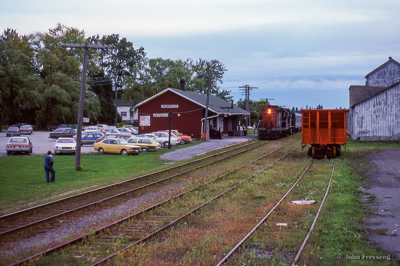 Shot during the 1978 TTC strike, VIA train 632 from Union to Stouffville slows for a stop at Markham's 1871-built station.  Originally a Toronto & Nipissing Railway structure, it has served passenger operations for the Midland Railway, GTR, CNR, VIA Rail, and presently GO Transit.

See Isaac Bryson's recent night shot here, 46 years later.  The station and main track remain, with everything else removed.

Scan and editing by Jacob Patterson.