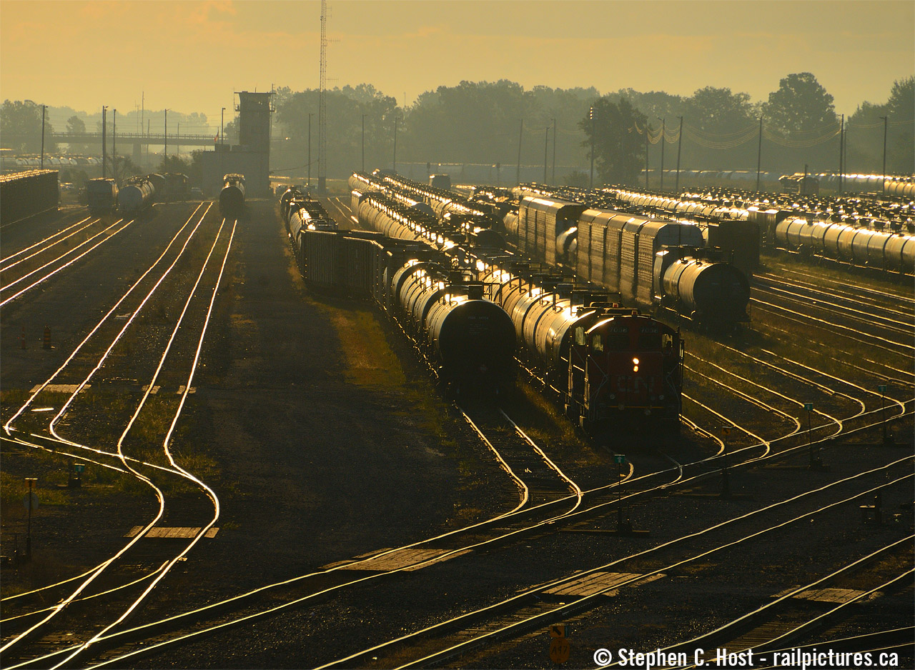 It's before 0800 and the CN Sarnia Plank Road yard job is busy switching "A" yard while the sun rises to the south. In the distance is the Sarnia yard tower. Sarnia is one of the largest yards on the CN system in Canada.