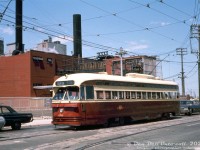 TTC PCC 4516 (A8-class, built by CC&F 1951) waits southbound on Weston Road waiting to make the left turn and head east on St. Clair Avenue. IT has just departed nearby <a href=http://www.railpictures.ca/?attachment_id=34071><b>Keele Loop</b></a>, operating on a St. Clair run eastbound and then northbound on <a href=http://www.railpictures.ca/?attachment_id=37064><b>Mount Pleasant</b></a> for <a href=http://www.railpictures.ca/?attachment_id=24456><b>Eglinton Loop</b></a>. In the background is part of Swift's (later Bunge, demolished around 2009), one of the handful of packing houses that once populated this area of West Toronto.
<br><br>
<i>Original photographer unknown, Dan Dell'Unto collection slide.</i>