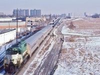 <br>
<br>
EMD on GO: Former Rock Island #380 ( ex RI #3004) a 1967 EMD built GP40-M-2,
<br>
<br>
shoves an eastbound hourly GO, with former Milwaukee #104A, a 1952 EMD built FP7A, rebuilt to GO APCU #911, leading, 
<br>
<br>
At CN Scarborough Junction, CN Uxbridge Sub mile 60.9 at left,  February 12, 1983 Kodachrome by S.Danko
<br>
<br>