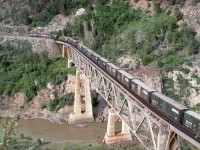 <br>
<br>
With a mix of box and empty wood chip cars, four BC Rail  SD40-2's; two mid train, crossing the Fraser River, 
<br>
<br>
 North of  Lillooet, B.C., near  Mile 155  Squamish Sub.,
<br>
<br>
May 25, 1989 Kodachrome by J. Art Clowes, collection of S. Danko
<br>
<br>
The Location:
<br>
<br>
Searching through google maps aerial photos, and based on the bridge design,  Lillooet appears to the closest match – would appreciate someone in the know to confirm.
 <br>
<br>
Noteworthy
<br>
<br>
In 2004 CN bought  BC Rail Ltd., the assets of the operating railway (the loco's, rolling stock).
<br>
<br>
And in 2004 CN leased the British Columbia Railway Co. (BCRC) assets (excluding the Delta Port assets) including the right-of-way and track materials, for a period of 60 years. Per the terms of the lease, the rail, ties and ballast are owned by BCRC as would be any replacement materials, which must be of the same standard as the original materials, unless the landlord consents otherwise. Also at the end of the lease the assets must be at the same standard as at the start of the lease – which may be interesting especially with regard to the Dease Lake extension the 202 mile Takla Sub-Division (Fort St. James to Minaret end of track).
<br>
<br>
The outcome of the above was a significant political scandal, whereas other parties bidding for the assets claimed the process was rigged. Quite the kerfuffle ensued. In 2010 two BC government political aides were convicted of breach of trust  and sentenced  serving two years in house arrest and 150 hours of community work.
<br>
<br>
sdfourty


