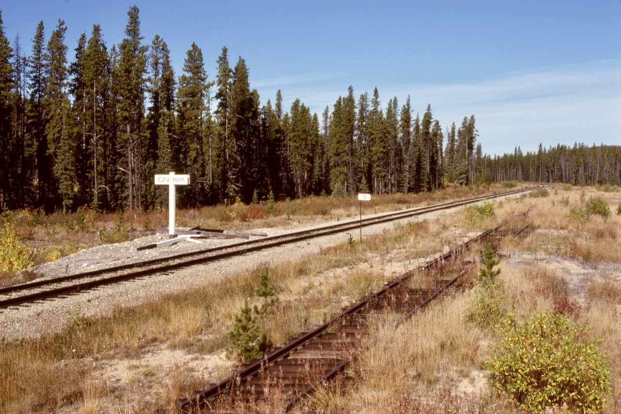 Ten and a bit years after CN’s Alberta Resources Railway was completed in May of 1969 between Swan Landing and Grande Prairie, this was the northward view at downtown Hoff at milepost 57 from Swan Landing, with a new style Station Name Sign apparently having just recently replaced the original.