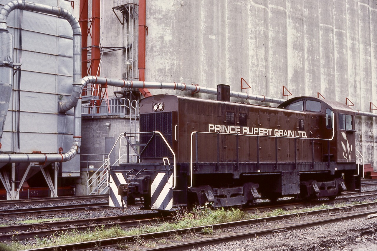 Believed to be the westernmost industrial railway operation in Canada (there were earlier logging lines on Haida Gwai), Prince Rupert Grain built a terminal on Prince Rupert harbour and alongside CN’s Skeena sub.  For switching loads and empties, in 1981 they acquired a 1955-built ex-Southern Pacific ALCo S-6 numbered (on paper, no external mark) 1219, as seen Monday 1981-10-05.

When expanding export terminal business for several commodities developed near Prince Rupert on Ridley Island, Prince Rupert Grain built a new terminal there in 1984, and the original site appears to be a wood pellet terminal now.