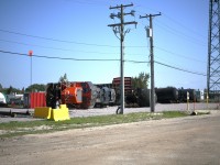 <b> Derailment Training </b> <br>
The derailment training site at the CN Campus in Transcona provides a realistic, hands-on experience for new and existing employees. <br>
CN 7083 and a variety of other rolling stock lay strewn across the ground just off Red Jones Road behind the training center building.