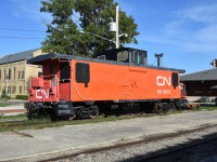 <b> Two-tone paint <br>
CN 79727 is a CN PSC built (9/1974) mainline caboose that is now on static display at the VIA Rail station/Dauphin Railway Museum in Dauphin, MB, Mile 121.7 CN Gladstone Sub., Mile 0.0 CN Togo Sub. <br>
The van has been vandalized over the years requiring the wire mesh window protectors. Track inspection lights, step lights, and other appliances have been destroyed and still require repair/replacement. <br>
Hopefully a fresh paint job is in the works in the not-too-distant future.