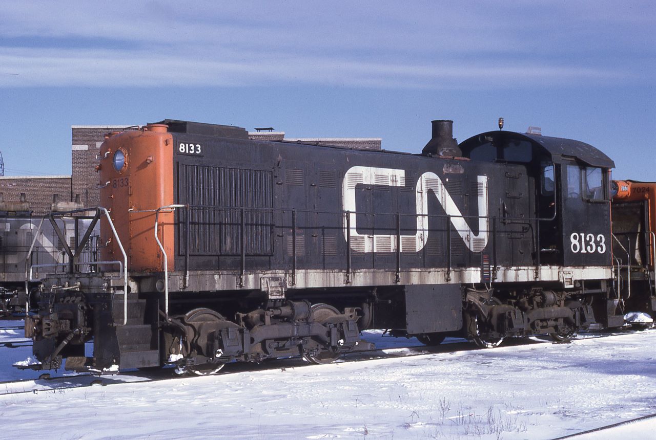 CN MLW S-2 switcher 8133 rests at Spadina Shops between assignments on Valentine's Day 1971.  A couple of interesting things about this unit is the font used for the cab number as it is the older style (pre-1961 style) and the classification data is not shown below the cab number. The unit was built by MLW in 1949 and is class MS-10a.