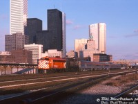 Departing downtown Toronto in the low December late afternoon/early evening light, CP Rail train #11 "The Canadian" (Toronto-Sudbury leg) passes by John Street interlocking tower (visible behind the Skyline dome) and the old CN freight loading platforms as it makes its way through the downtown Toronto Terminals Railway trackage to CP's Galt Sub at Bathurst Street. Lead unit is CP FP7 4069, sporting bright "Action Red" paint with later 8" striping. Trailing is steam generator-equipped RS10 8478 in very ratty maroon & grey "Script" paint. A short consist of six stainless steel Budd cars follow (no Park car this late in the game for #11/12).
<br><br>
All the usual suspects are in attendance in this pre-condo boom photo of Toronto's downtown skyline: the TD, BMO and RBC towers, CP's Royal York Hotel, the brown CNCP Telecommunications building at 151 Front Street, and Union Station off in the background beyond the new yellow CN Tower pedestrian bridge.
<br><br>
<i>Bill McArthur photo, Dan Dell'Unto collection slide.</i>