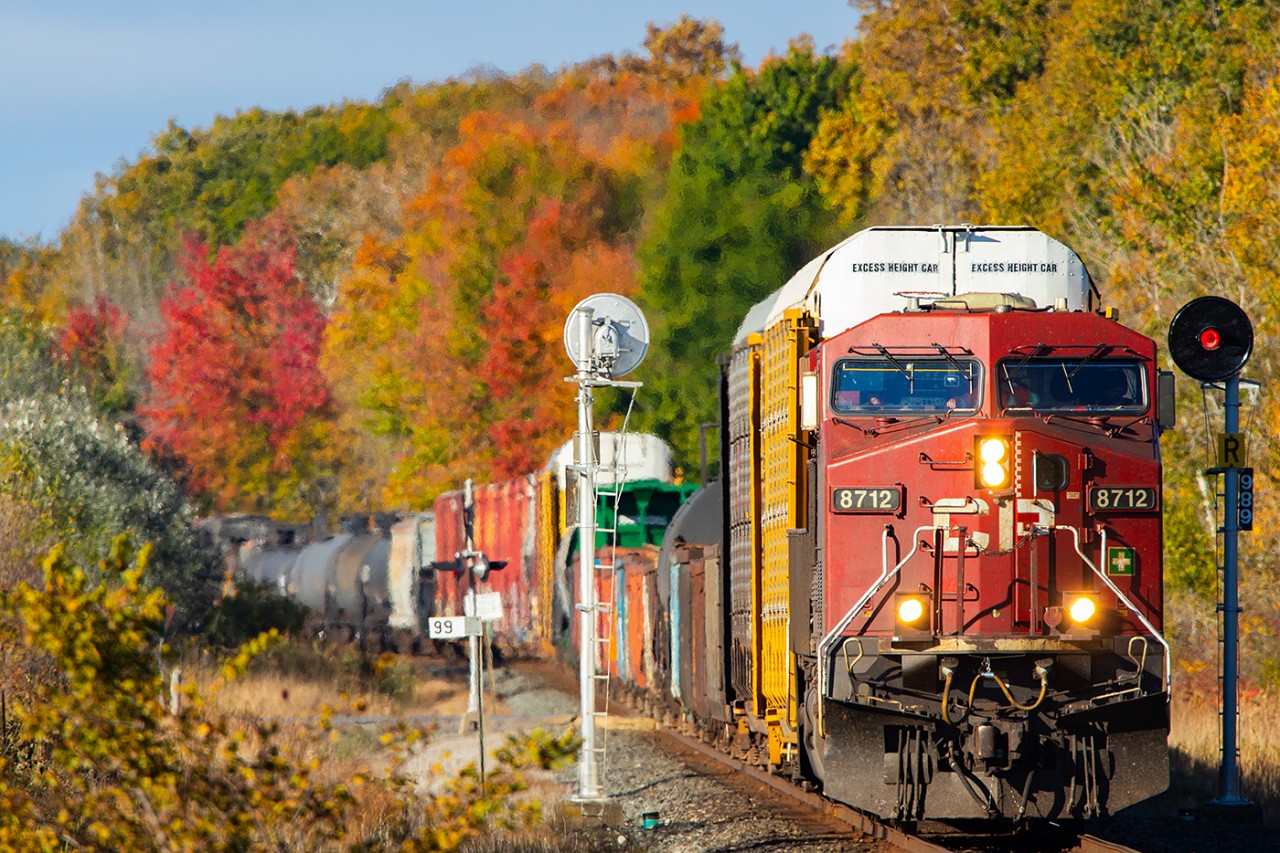 CP 8712 pulls an eastbound CPKC past Trenton as the autumn leaves have peaked.