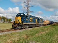 The daily CSX interchange train seen here about to enter the "south" interchange tracks on CSX's Sarnia Subdivision, the power will run around its cars before making the connection to CN's St. Clair River Industrial spur and into CN's large yard at Sarnia, cars are dropped in the CN yard, new ones picked up and return back to CSX rails, this is the only way for CSX to get it's traffic to and from Sarnia as it's Canadian operations are isolated from the rest of the network. Power is locally assigned GP38-2's 2672 and 2690 and ex Chessie caboose 900032. The GP38's and caboose are no longer used in Sarnia. 