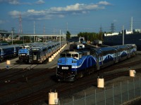 EXO 1209 is leaving the maintenance centre in Montreal at the start of the afternoon rush hour last Friday. At left is wrecked F59PH EXO 1346, fatally damaged in a collision with CN X376's light power last November.