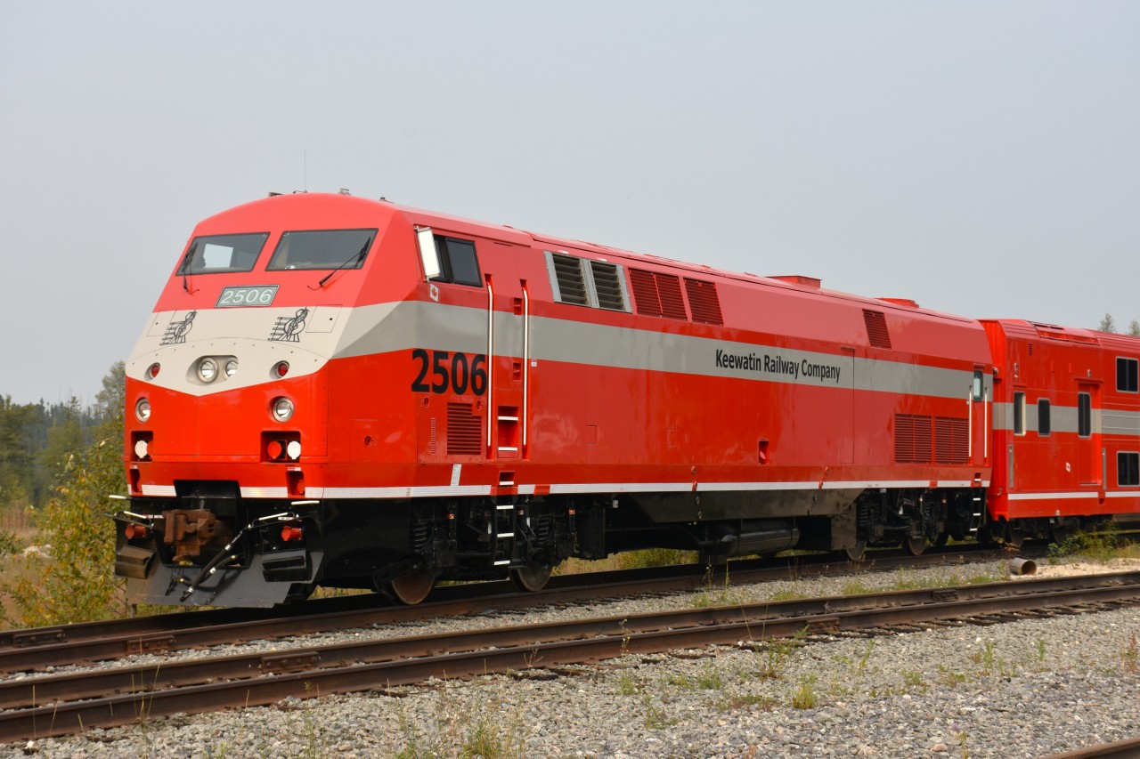 The second railroad in Canada owned by a First Nations group is the Keewatin Railroad Company of Northern Manitoba (first was Tshiuetin in N. Quebec).  They received over $6M for start up from the governments (as well, the First Nations kicked in $500,000). The line is operated from The Pas MB to Pukatawagan, a small village in the interior, which is not accessible by road. Formerly this was operated by the Hudson Bay Railway, but severe flooding resulted in the HBRY wanting out of the operation, and since the remote communities along the line needed this vital link, the Keewatin was formed to take it over in 2006.
The passenger service is operated by a pair of former GATX geeps and VIA equipment. The twice weekly train operates as a mixed, with goods for the communities along the line tacked on the end. It stops at Cranberry Portage as well as many flagstops along the way.
With a need for their own equipment, the federal government came up with another $3.2 million to purchase two former AMTK units and a couple of Long Island double coaches.
I showed up expecting to see this set in operation.  Nope. Its mothballed, for the time being. I was told the KRC was waited for a couple more coaches.
Why? In this photo, check the positioning of the coach doors in comparison to the ground level. Now draw your own conclusions.