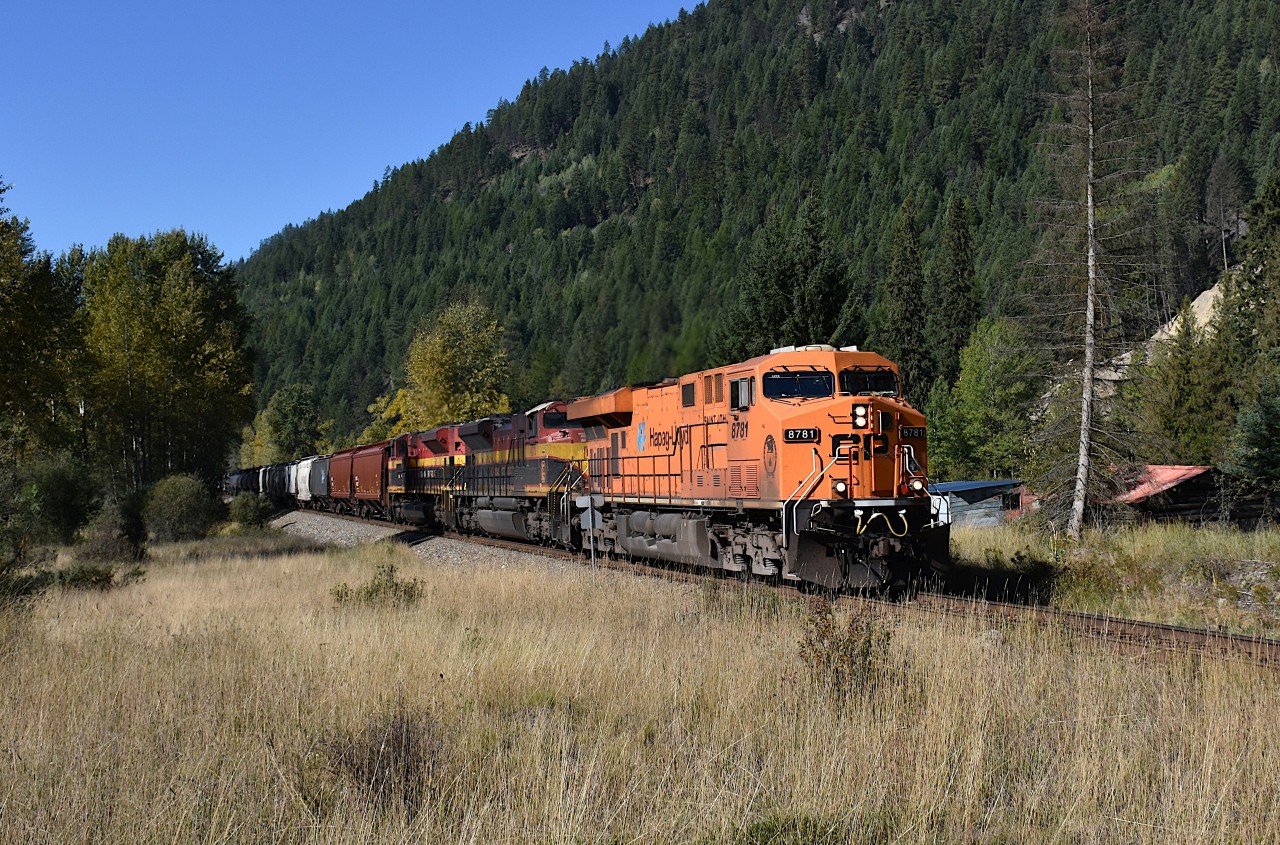 This train worked at a location mile 137.9 referred to as Tochty for over an hour; so the plan was to find a spot worthy of catching it running eastward. Tochty was too tight, from the highway it was a shot against the sun and the other side of the work area was the Moyie River. And no road in.
So, we headed about 5 miles eastward, little over halfway to Moyie (mile 128) to Bateman Rd, a little gravel access to a couple of homes as well as a rail crossing.  And waited. It was a glorious day, clear skies, nice temperatures, and the reward was CP 8781, KCS 4070 and 4155 rolling thru in a rather nice setting. Not easy to shoot in these parts, so much of it is heavily wooded. And this is not a very well used line. Pity the Hapag-Lloyd paint could use a good wash, but there is no money in that. :o)