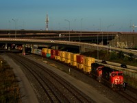 An SD75I pair leads CN 401 out from under the Turcot Interchange.