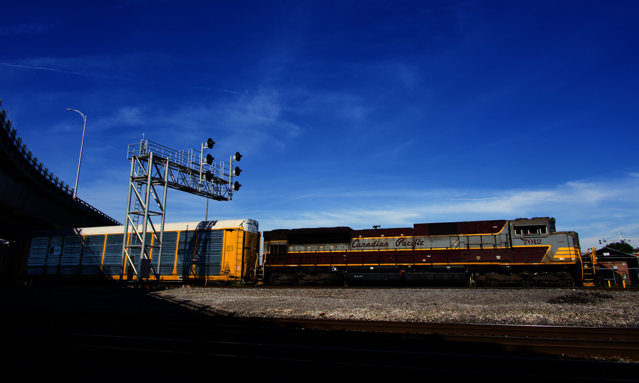 Heritage unit CP 7012 leads a 526-axle long CPKC 230 through Dorval.