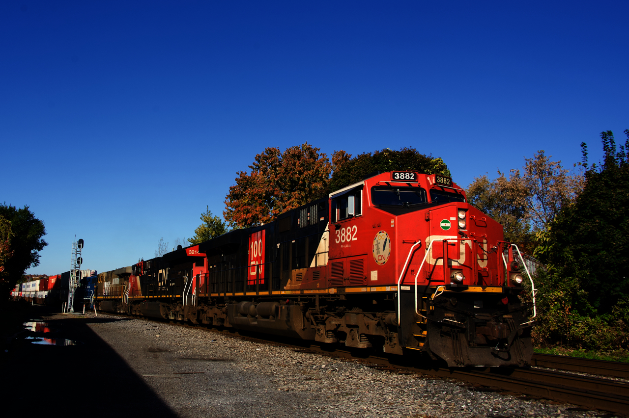 A CN 100 unit leads CN 120 past MP 4 of CN's Montreal Sub.