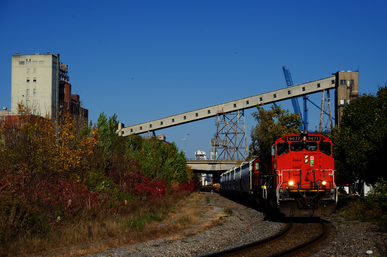 CN 500 is leaving the Port of Montreal with hoppers and baretables.