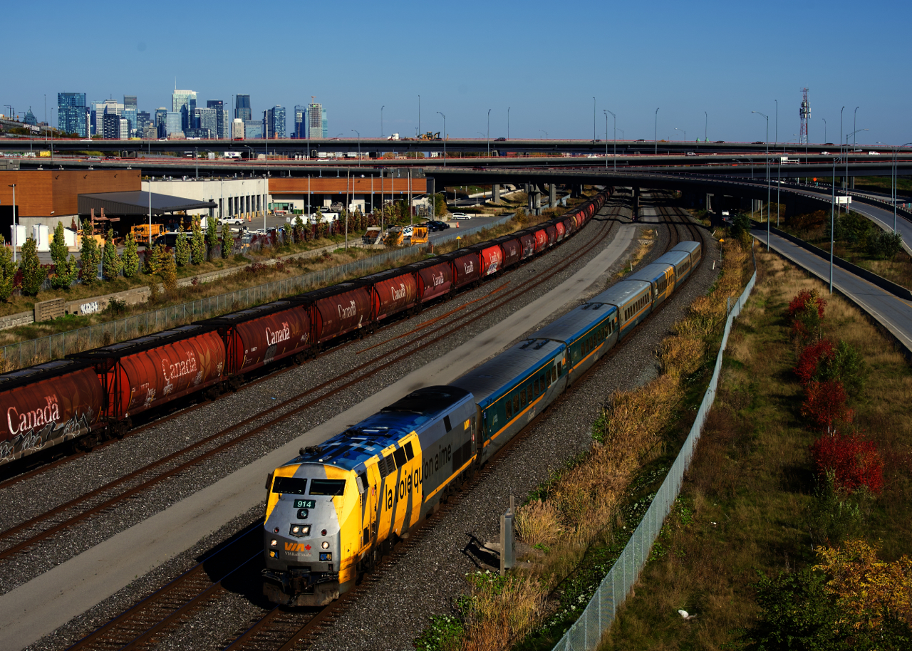 A rare sight these days, as VIA 67 passes a long string of cylindrical hoppers parked on Track 29 of the CN Montreal Sub.