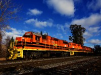 A trio of GP38/GP38-2s leads QG 501 southbound on the Adirondack Sub, on its way to CPKC's St-Luc Yard.