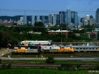 A wrapped F40 and P42DC are seen at the Montreal Maintenance Centre from a passing REM train.