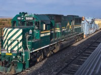 <b> Green Power </b> <br>
As VIA 693 The Hudson Bay backs its way slowly to the station track in Churchill, HBRY 5000 stands ready to move out with a loaded GREX ballast unloading Dump Train from the HBRY Yard at Mile 509.8 Herchmer Sub. on what is shaping up to be a gorgeous September 19, 2024 da in this wonderful remote location. <br>
Another of my pics graciously edited by Benny :-)