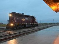 <b> Service appointment required </b> <br>
HLCX 1084 is in front of the station in the yard at Churchill, MB in a steady, light rain switching cars from the inbound way freight, and marshalling others from the ramp tracks that will be departing on tomorrows southbound run. <br>
A ditch light bulb needs to be replaced on the rear of the locomotive at the next service opportunity.