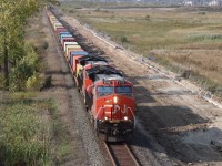 Westbound Intermodal train is about to pass under Britannia Road and knock down the signal at Ash. Preparatory works continue for the second main track between Ash and Derry part of the construction works for the future CN Milton Logistic Hub.

