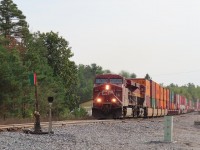 A northbound intermodal is about to pound the switch of the spur track at Midhurst. Up until 2011 Midhurst had a siding and a couple of back tracks seeing occasional use. Today the back tracks sit disconnected and lying under a huge pile of used crossties. 