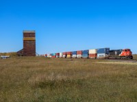 Q 18051 27 cruises past the wooden elevator at Nielsen with CN 3331 featuring a retro CN logo leading. 