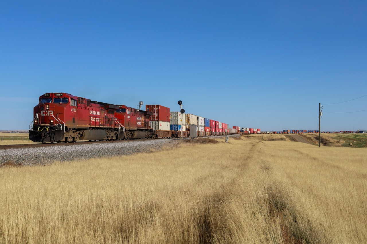 CPKC 119 gets up to trackspeed, after climbing out of the South Saskatchewan River Valley and a crew change in Medicine Hat.