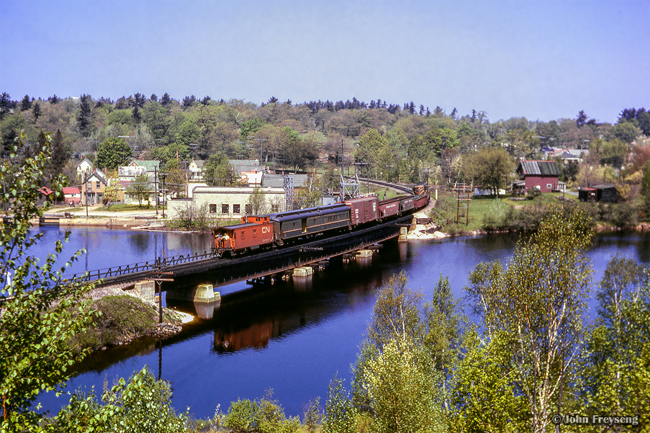 Shortly after the passage of the Super Continental, mixed train M215 from South Parry to Capreol gets underway behind GMD GP9 4334.Scan and editing by Jacob Patterson.