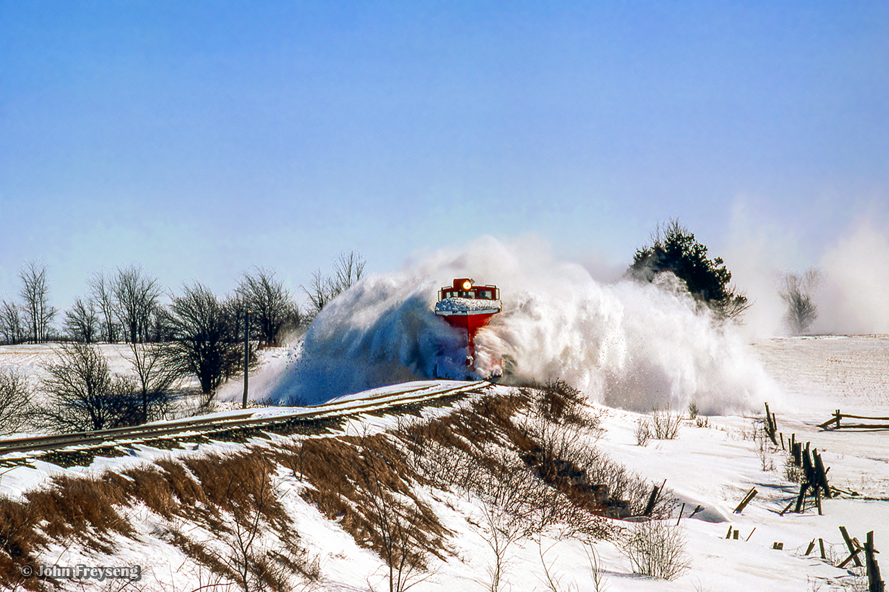 After meeting the Teeswater Sub wayfreight at Grand Valley, plow extra 8424 west approaches Arthur.  The location is not exact, however the culvert is likely just east of Sideroad 7.Scan and editing by Jacob Patterson.