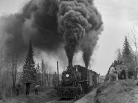 With railfans all around, the joint excursion of the Upper Canada Railway Society and Canadian Railroad Historical Association behind E-10-a 2-6-0 90 and N-4-a 2-8-0 2649 thunders by during a runpast near Ormsby Junction, where the seven mile Coe Hill Sub left the mainline.
<br><br>Departing Belleville amid the light rain that morning at 0645h - with a crew from the National Film Board setup in the baggage car - the excursion ran along the Campbellford Subdivision to Anson Junction, taking the east leg of the wye onto the Marmora Subdivision. The train would pause briefly at Bancroft before proceeding three miles north to York River where the train could be wyed for the return trip. Arriving back at Anson Junction, the excursion would continue south into Trenton, turning on the wye before returning north to Trenton Junction to rejoin the Oshawa Sub mainline for the short twelve mile run back to Belleville. The special reached a top speed of 55mph on the high iron, running barely 30 minutes ahead of Toronto - Montreal train 6, due into Belleville at 1815h.

<br><br>Notes of the trip per John Freyseng's extensive article in the June 1959 UCRS newsletter. Neither of these locomotives would last another year, with 90 meeting the torch in February 1960, and 2649 that March.


<br><br><i>John A. Krave Photo, Jacob Patterson Collection, 4x5 Negative.  Geotagged location is approximate.</i>