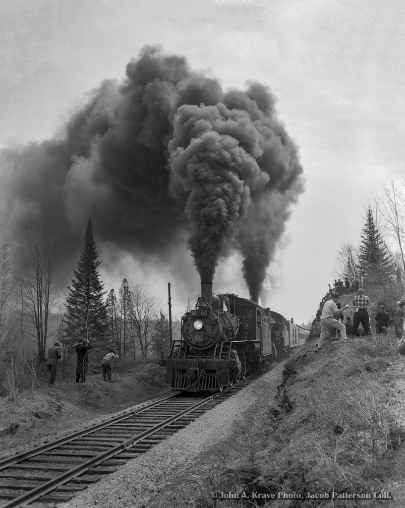 With railfans all around, the joint excursion of the Upper Canada Railway Society and Canadian Railroad Historical Association behind E-10-a 2-6-0 90 and N-4-a 2-8-0 2649 thunders by during a runpast near Ormsby Junction, where the seven mile Coe Hill Sub left the mainline.
Departing Belleville amid the light rain that morning at 0645h - with a crew from the National Film Board setup in the baggage car - the excursion ran along the Campbellford Subdivision to Anson Junction, taking the east leg of the wye onto the Marmora Subdivision. The train would pause briefly at Bancroft before proceeding three miles north to York River where the train could be wyed for the return trip. Arriving back at Anson Junction, the excursion would continue south into Trenton, turning on the wye before returning north to Trenton Junction to rejoin the Oshawa Sub mainline for the short twelve mile run back to Belleville. The special reached a top speed of 55mph on the high iron, running barely 30 minutes ahead of Toronto - Montreal train 6, due into Belleville at 1815h.

Notes of the trip per John Freyseng's extensive article in the June 1959 UCRS newsletter. Neither of these locomotives would last another year, with 90 meeting the torch in February 1960, and 2649 that March.


John A. Krave Photo, Jacob Patterson Collection, 4x5 Negative.  Geotagged location is approximate.