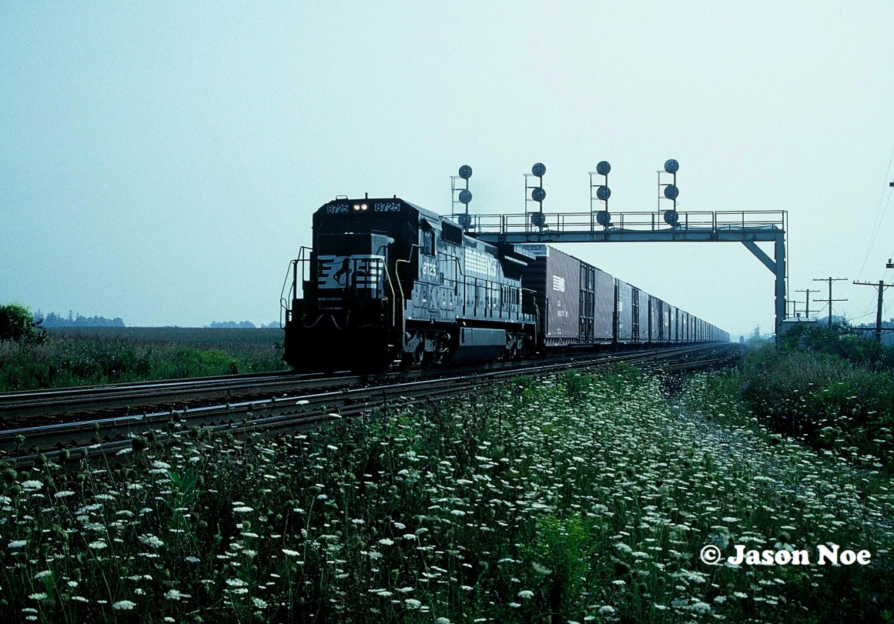 In summer 1994, Norfolk Southern trains 327 / 328 were changed over from operating across the CN Cayuga Subdivision between Fort Erie and St. Thomas to running via CN’s Grimsby, Dundas and Talbot subdivisions. On July 29, 1994, NS C39-8 8578 officially led the first 328 on this new routing.

While some did already know of this permanent change, my friends and I had only heard rumblings about the possibility as the news was slower to travel 30 years ago. Until early one foggy morning while waiting at Paris West, we heard a strange American horn blowing on an approaching westbound for the Broadway Street crossing in town. A couple minutes later and I would be shooting my first NS 327 on the new routing with C40-8 8725 leading solo to St. Thomas. Both 327 and 328 would go on to operate via this route for over the next twelve years, until 328 ran for the last time on December 30, 2006.