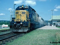 During an August afternoon, the station platform is bustling with passengers as Ontario Northland Railway train 698 prepares to depart North Bay, Ontario with GP38-2 1803 leading to Toronto. 