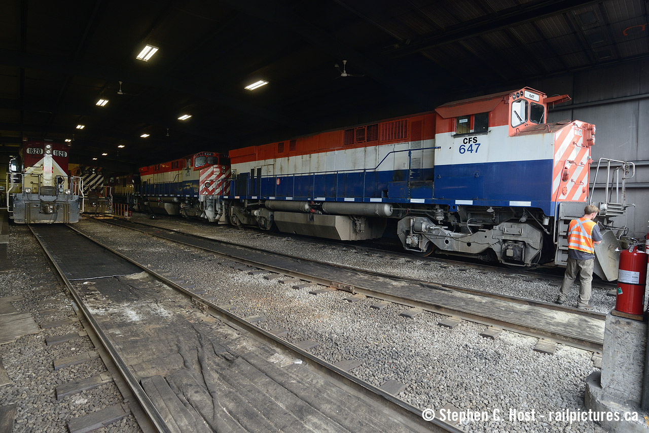 Behind the doors for the last time, M420's 647 and 646, now lettered for CFS (Sartigan Railway) are about to be removed from the shop as they are being shipped out to Quebec via CN. This engine house was usually filled to the gills with locomotives but with jobs already on duty there was some room to see inside a bit more. This shop was owned by OSR but was sold by them (Along with the yard office) to the Guelph Junction Railway fairly recently and is planned to be leased out. The VHA has been painting some coaches in here over the last few months.
A few days after this photo, CN would finally grab these two from the interchange only to leave them behind in XV yard for a few days.