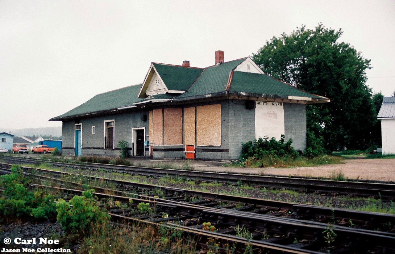 The morning fog has just lifted in the village of South River, Ontario on the CN Newmarket Subdivision. The old CN station, constructed during 1884 by the Northern and Pacific Junction Railway, is viewed sitting boarded-up with the “Save our Station” sign affixed to the one end over its windows. Situated at Mile 188 of the line, the village’s railway history was deemed to important to be lost. In turn the village was able to see that the station was saved, and it was cosmetically restored in later years.

Presently, work began this spring to prepare it for the resumption of Ontario Northland passenger rail service sometime during 2026. The current Ontario government is following through with a commitment to re-introduce passenger service from Timmins to Toronto and South River is one of the stops. Reportedly, it will be the only scheduled stop between North Bay and Huntsville on the re-introduced ONR passenger service. An article in the North Bay Nugget had said that renovating the former train station back to life again was estimated to cost $414,000.