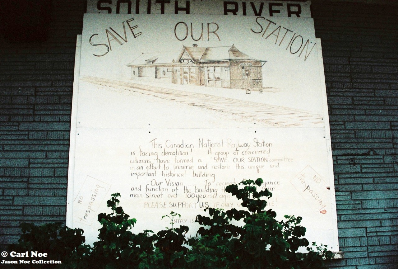 The morning fog has just lifted in the village of South River, Ontario on the CN Newmarket Subdivision. The old CN station, constructed during 1884 by the Northern and Pacific Junction Railway, is viewed sitting boarded-up with the “Save our Station” sign affixed to the one end over its windows. The sign is viewed here as the village’s railway history was deemed to important to be lost. In turn they were able to see that the station was saved, and it was cosmetically restored in later years. Presently, work began this spring to prepare it for the resumption of Ontario Northland passenger rail service sometime during 2026. The current Ontario government is following through with a commitment to re-introduce passenger service from Timmins to Toronto and South River is one of the stops. Reportedly, it will be the only scheduled stop between North Bay and Huntsville on the re-introduced ONR passenger service. An article in the North Bay Nugget had said that renovating the former train station back to life again was estimated to cost $414,000.