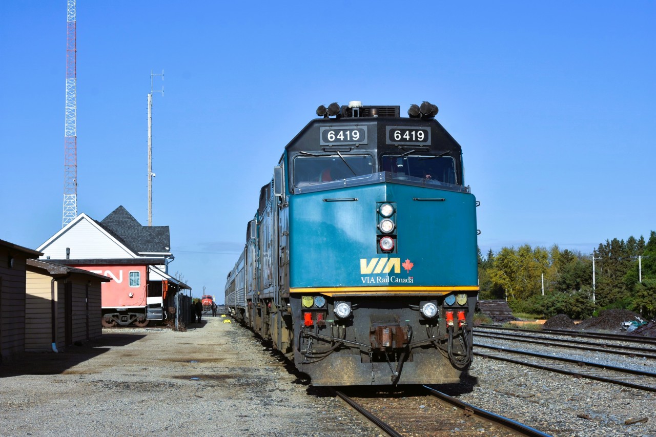 CANORA, this station stop, CANORA  
VIA 6419 is todays leader on VIA 692 The Hudson Bay at Canora, SK. Mile 124.9 CN Togo Sub. 
On static display at the end of the station/Railway Museum is transfer van CN 76659, while in the distance you can see CN 3049 which is very much still in service and waiting for its next assignment. 
The VIA yellow step boxes glow in the bright sun waiting for us to entrain once the ALL ABOARD call is given. :-)