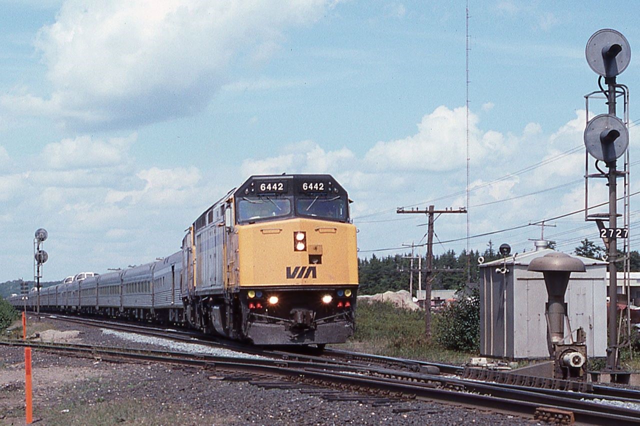 After a GREAT meet with a short northbound freight where neither train stopped, VIA Train #2 pulls out of the south end of the siding at Suez, Ontario in August 1998.  VIA 6442 leads the 21 car this day.