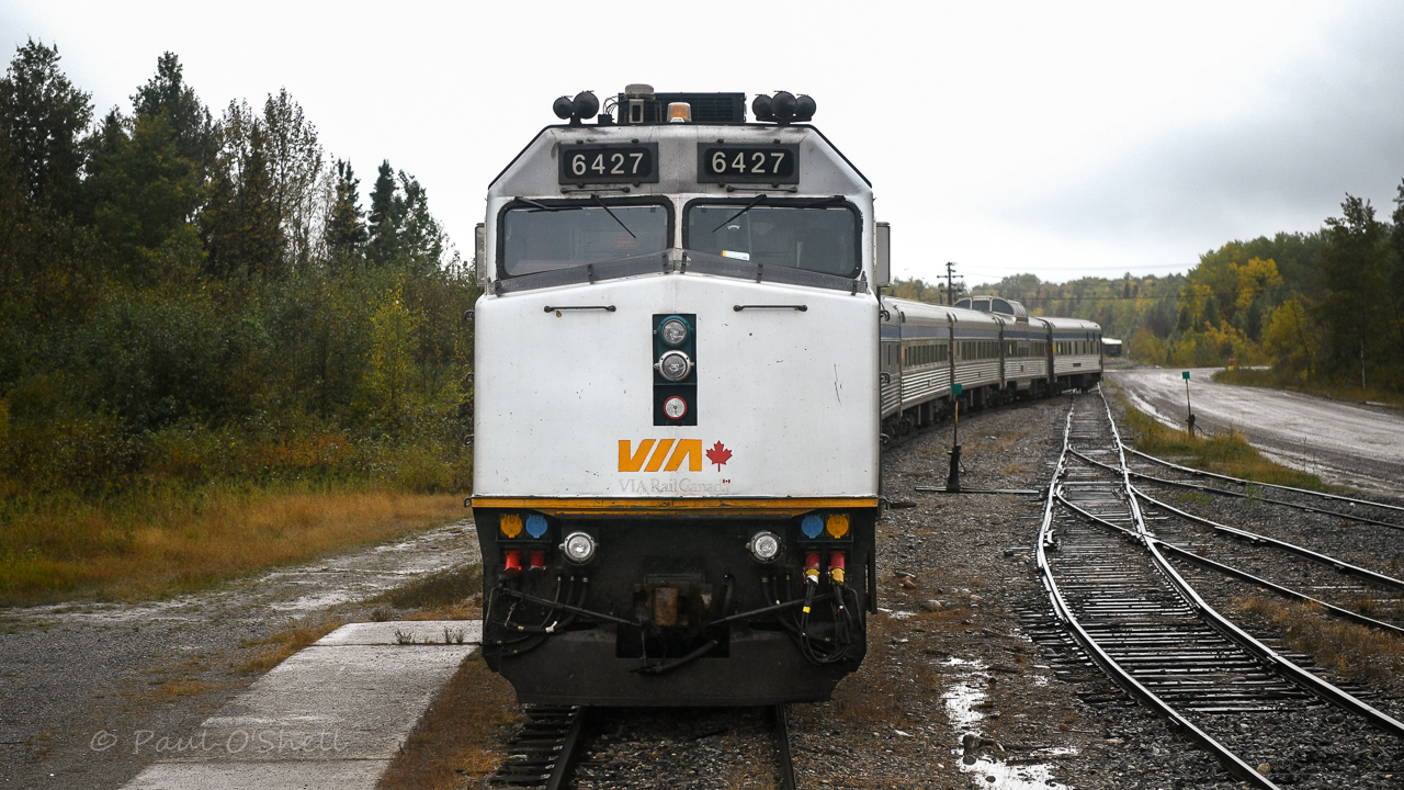 Up close and personal  
From the rear vestibule of VIA 8224 Chateau Roberval sleeper on VIA 693 The Hudson Bay, sits VIA 691 The Hudson Bay tucked into the station track just a couple of car lengths back at Thompson, MB Mile 30.5 HBRY Thompson Sub. 
Both trains are getting a headend crew change and full service on this overcast and rainy September 18, 2024 afternoon. 
photo edited by Benny