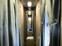 <b> Two-up two-down </b> <br>
Soiled linen bags lay in the hallway in the roomette end of sleeping car VIA 8224 Chateau Roberval. <br>
Room attendant Brian has just finished making up the two-up two-down staggered roomettes (cabin for one in VIA lingo) and is now tending to the double bedrooms in the middle of the car. <br>
With all the 'cabins for two' sold out on this trip, it was my first time in a roomette since the early 1980's. I found the bed more comfortable than in the bedroom for two that I usually occupy, but it was just a little too cramped for those of us that have to get up in the middle of the night (if you know what I mean). ???? Going forward, it's back to a full bedroom for two for me. <br>
I sure hope these Budd stainless steel sleepers are around for another 10-12 years at least.