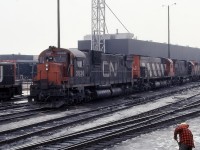 It's about as dreary a day as an Ontario winter can offer. A sectionman is cleaning out switches at the diesel shop, while on the ready tracks sits what today would be called "heaven". An SD40, 3 M636's and a C630 await their next assignment. Those were the days my friend. 