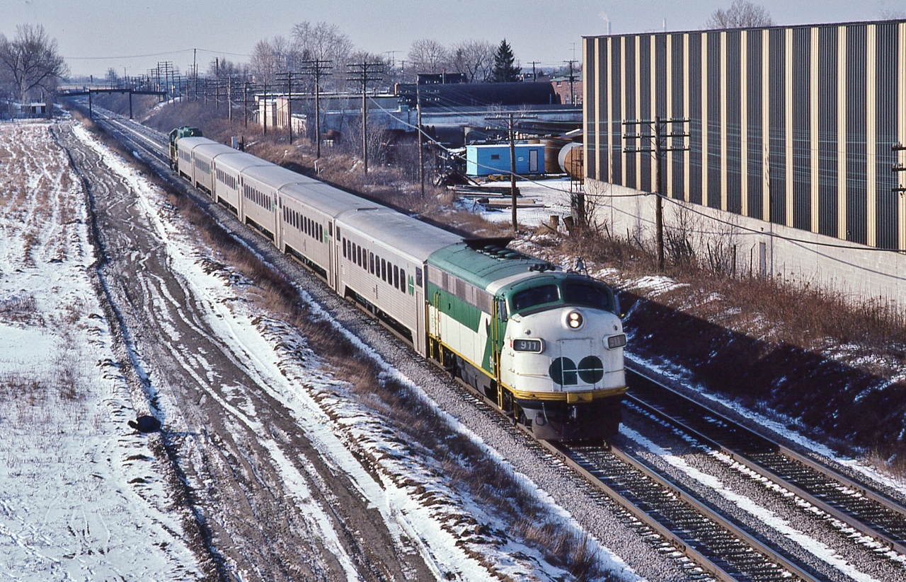 EMD on GO: Former Milwaukee #104A, a 1952 EMD built FP7A, rebuilt to GO APCU #911 leads an eastbound, 


powered by GO 725, former Rock Island #380 ( ex RI #3004) a 1967 EMD built GP40-M-2,


At CN Scarborough Junction,  


With the NIKKOR 135mm f2.8 AI manual focus lens;  February 12, 1983 Kodachrome by S.Danko


       MILW 104A  


sdfourty