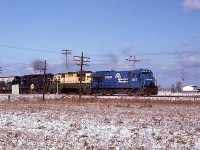 What was a rare catch for me back then was the "CPBU" in daylight. I was a bit of a shock to see this. Like most other fans, I just accepted the fact this generally ran under cover of darkness.
Here it is, Toronto to Buffalo run thru,  moving along at a good clip as it crosses Grimsby Rd (12) as I photographed it from alongside of Young St. The train is close to the Smithville name sign, another quarter mile along.
Power is CR 2887, 3634 (x-RDG) and 8071.