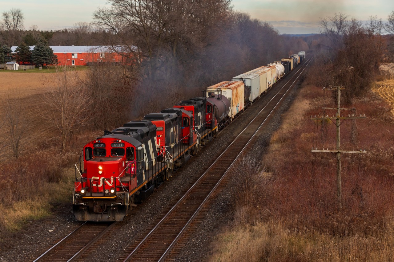 One of 14 zebra GP9RMs left on CN's roster (5 in the Toronto pool) leads a rare trio of GP9RMs westbound as they highball down the Dundas sub after running around their train at Paris Junction. This particular trio was CN 4131, CN 7025, and CN 4136; who collectively had 198 years of service at the time the photo was taken. To my knowledge, there has not been another GP9 trio in London in the year since, although some wacky sets including 3 GP9s have occurred a bit to the north in the Kitchener terminal.