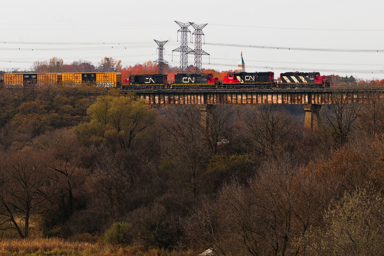 Not something I was expecting to see the other day whilst rolling the dice with CN was the daily Brampton-turn L559 heading back to Mac Yard with a rare quartet of majority GP9s crossing the Humber River. I had actually been waiting for 4125-9555 on L529 coming back from the Highbury spur so the zebra stripes on the leader instinctively looked like exactly what I was looking for, until confusion hit my face seeing 2 more GP9s emerge from the descent from Martin Grove. Ultimately, 4130-9449-7270-7032 made up the consist, the pair of back-to-back duos implied that the second half was lifted from Brampton IMS as they are fitted for the standard use of RCL by BIT yard. 
 
The debate I'm having with myself right now which I'll open up to the floor is whether or not the crew aboard 7032 is evidence to the contrary and this quartet originated in Mac or if they took a lunch right after lifting the power. Also worth noting the exhaust coming out of the two GP9s, but I don't think that's quite as compelling as 559 could've needed the extra help and borrowed power from BIT.